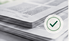 A stack of documents marked with a verification tick